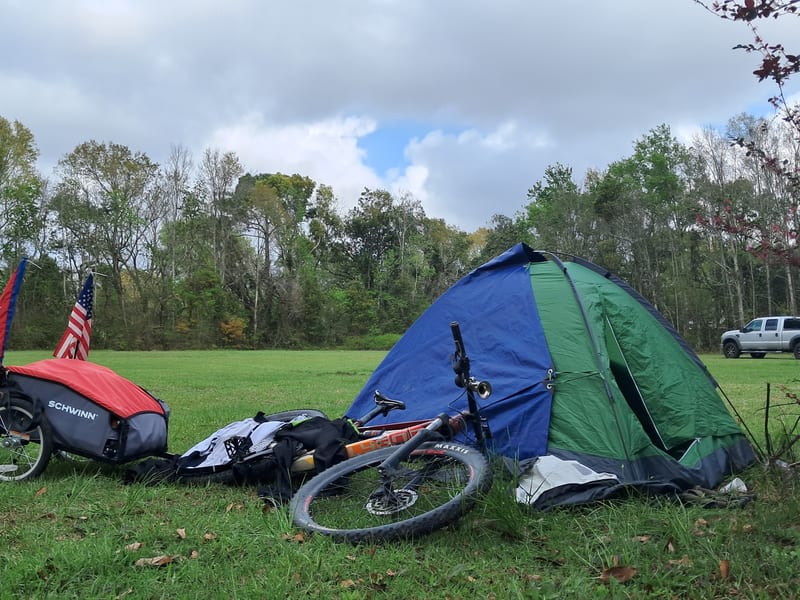 Bike camping setup in a grassy field
