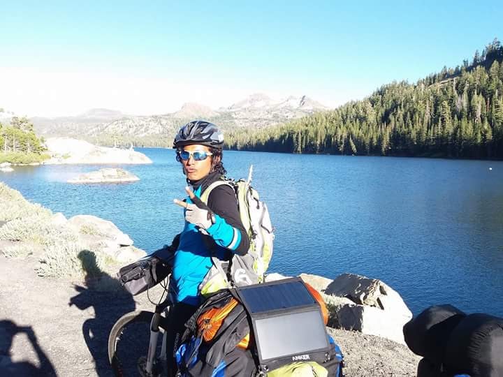 Cyclist at alpine mountain lake